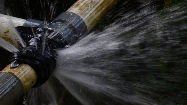 A severe burst pipe spraying water, requiring emergency service from Drainstar Plumbing Inc