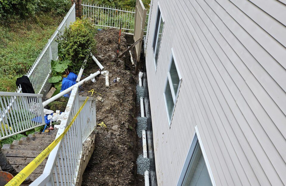 Exterior waterproofing trench and weeping tile installed by Drainstar Plumbing Inc. along a foundation